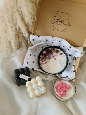 A beautiful display of soy candles featuring floral and geometric designs in a stylish setting.